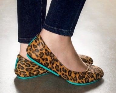model wearing jeans and leopard print tieks flats
