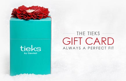 mini tieks box with a red flower topper sitting in snow
